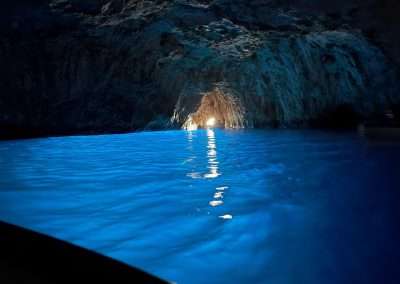 Vivid blue water inside Capri’s Blue Grotto, with sunlight shining through the cave entrance