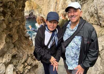 Mike and Jacquie standing beneath a stone arch near the Blue Grotto on Capri