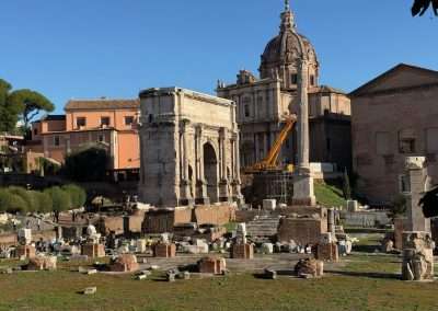 Arch of Septimius Severus surrounded by ruins in the Roman Forum